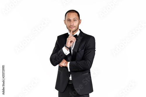  Serious man in a tuxedo on a white background. Isolated picture of the agent.