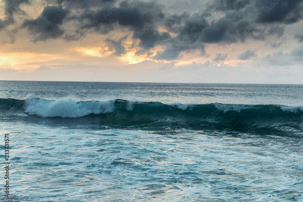 Beautiful sunset shoreline at tropical sandy beach in Oahu island, Hawaii