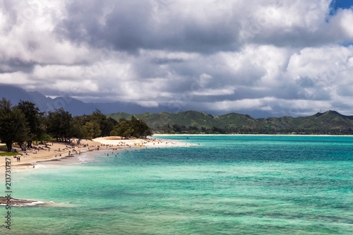 View of Kailua beach with lots of people sunbathing and swimming.