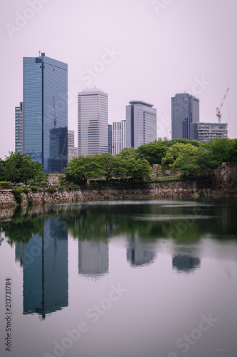 Osaka city modern downtown building with reflection in water