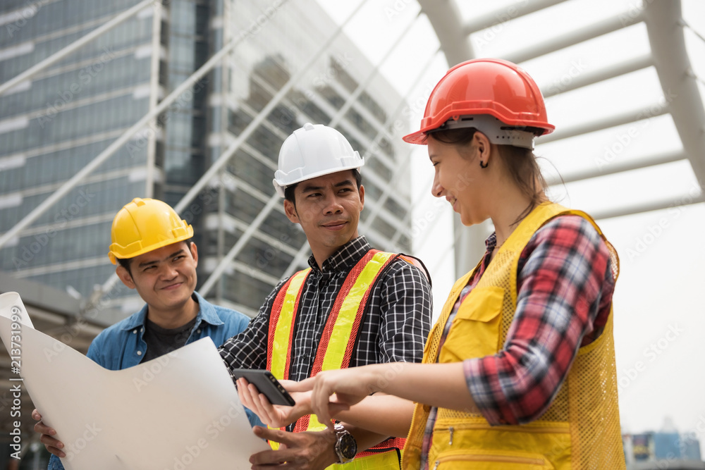 Construction team check plan from smartphone Construction team check plan from smartphone