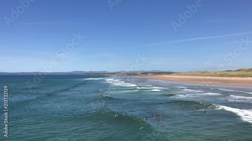 SURFER SWIMMING OUT ON THE WAVES photo