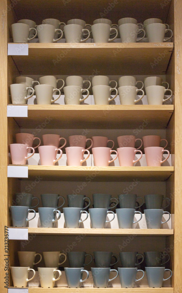 Mugs on the shelves in the shop window. Mugs on the shelves in the shop window.