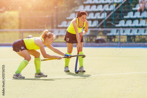 Two young field hockey player girls waiting for penalty shot