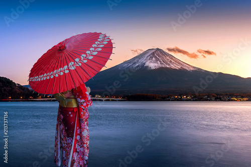 Asian woman wearing japanese traditional kimono at Fuji mountain. Sunset at Kawaguchiko lake in Japan.