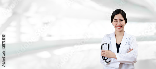 Portrait of young attractive female asian doctor or physician crossed arms holding stethoscope medical equipment, smiling and looking at camera in hospital feeling professional confident for banner. Free Download Portrait of young attractive female asian doctor or physician crossed arms holding stethoscope medical equipment, smiling and looking at camera in hospital feeling professional confident for banner. - GFXLoad