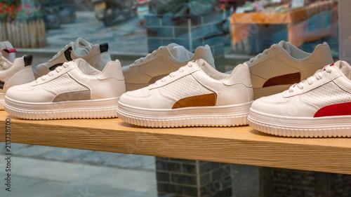 Sneakers in the showcase of fashionable shop