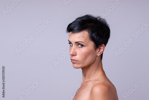 Suspicious woman looking sideways at the camera