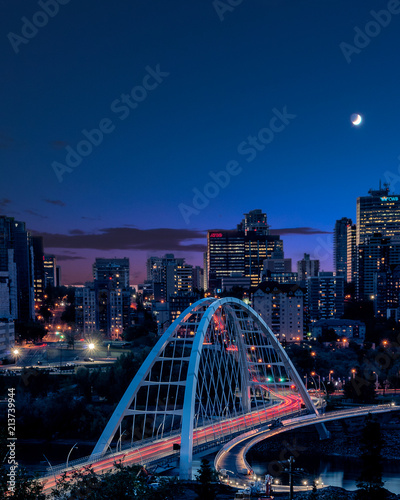 Light trails as traffic goes across the new bridge during blue hour in Edmonton (YEG), Alberta , Canada. photo