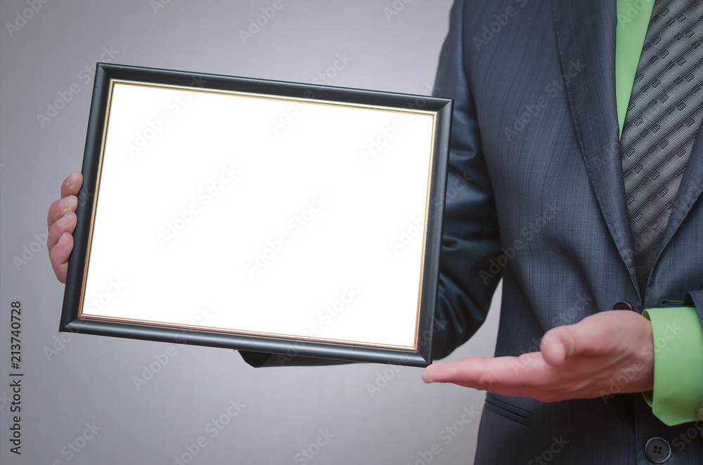 Blank diploma or certificate mock up in businessman hand. Empty photo frame border with copy space. Blank diploma or certificate mock up in businessman hand. Empty photo frame border with copy space.