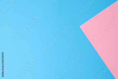 Blue and pink papers geometric lay down as a background.