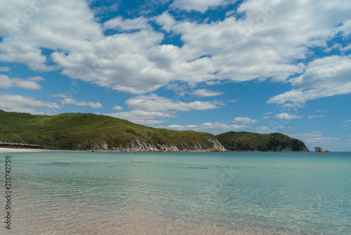 Fototapeta Naklejka Na Ścianę i Meble -  Beautiful blue water bay, empty beach, crystal clean water, blue sky on sunny day