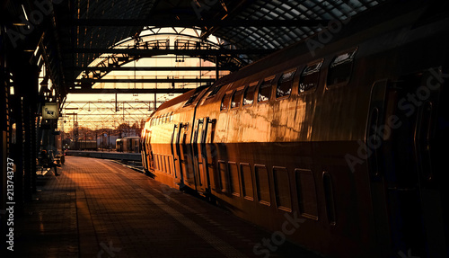 Train in sunset in station in Amsterdam