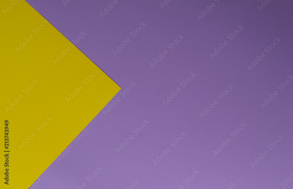 Yellow and purple papers geometric lay down as a background. Yellow and purple papers geometric lay down as a background.