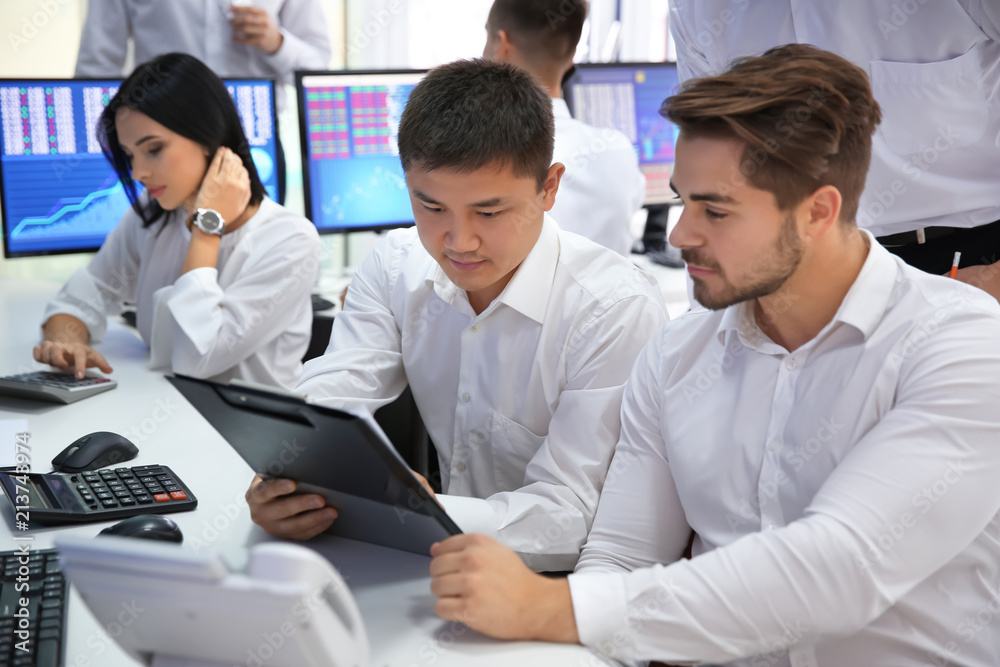 Team of stock traders working in office