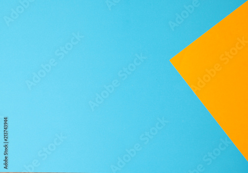 Blue and yellow papers geometric lay down as a background.