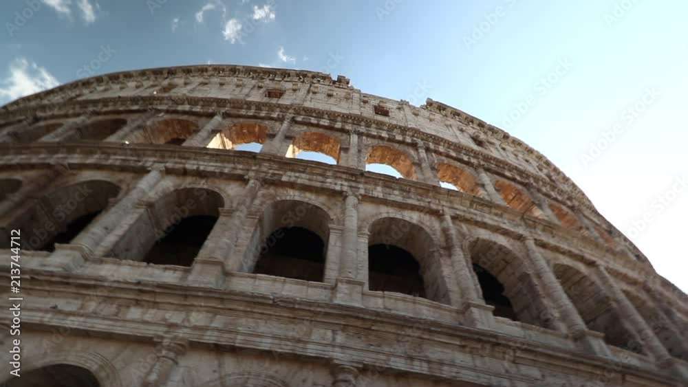Rome colosseum looking up pan left to right. Day time blue skies wide shot Rome colosseum looking up pan left to right. Day time blue skies wide shot