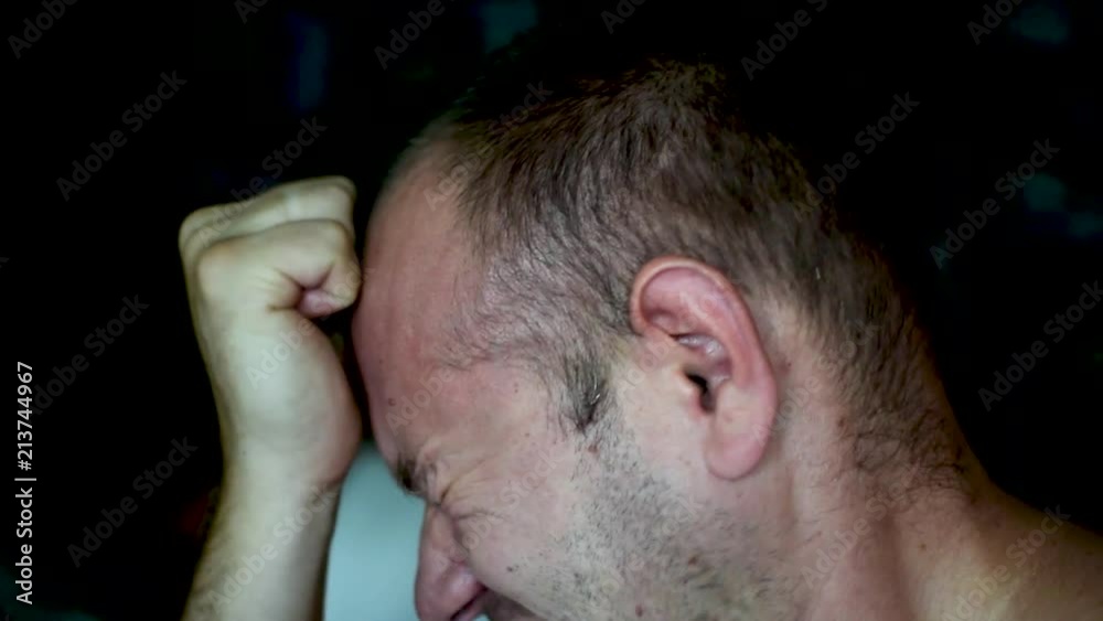 A man tortures himself, beating himself on the cheeks and head. A man tortures himself, beating himself on the cheeks and head.