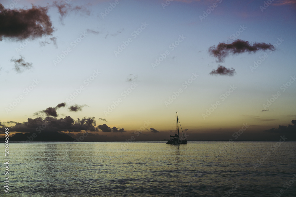 boat in the ocean at sunset 
