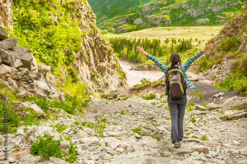 Happy hiker with her arms outstretched, freedom and happiness, achievement in mountains