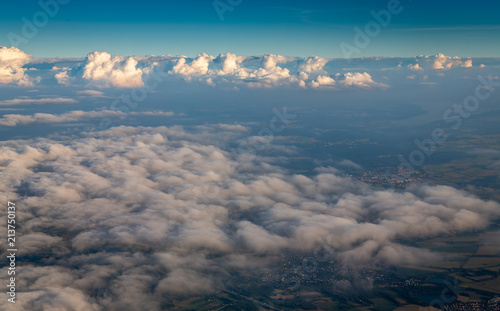 Fototapeta Naklejka Na Ścianę i Meble -  View from airplane window showing clouds and mountains in central europe.