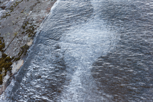 a layer of verglas or ice on rocks coul be very dangerous for climbers photo