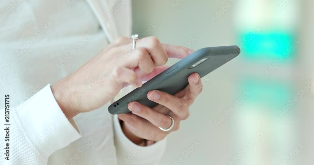 Close up Woman sending sms on cellphone inside shopping center Close up Woman sending sms on cellphone inside shopping center