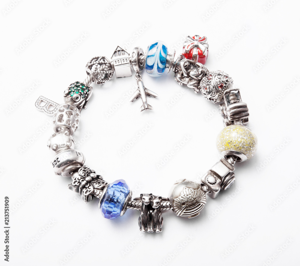 Obraz premium silver bracelet with charms on grey background