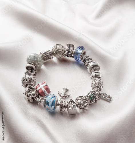 silver bracelet with charms on grey background