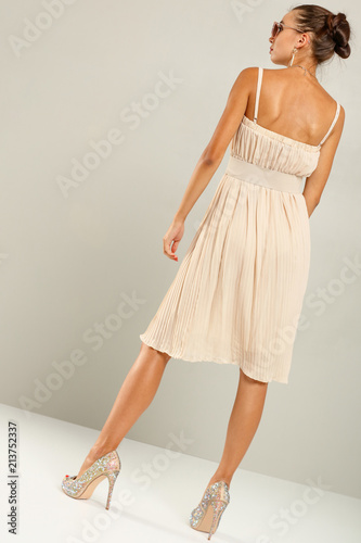 slim young woman in dress. Fashion photo in studio. 