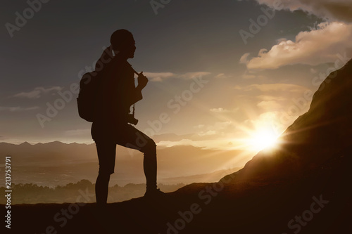 Silhouette of traveler woman hiking the mountain