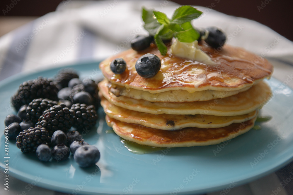 Pancakes with blackberries and blueberries on a plate