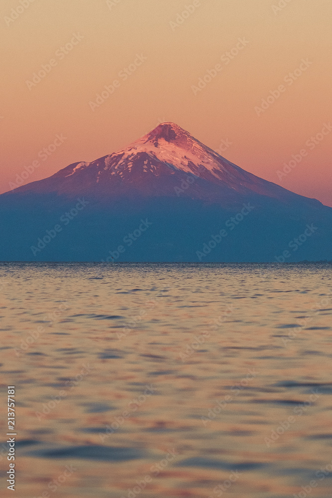 Chile. Pukon. Snow-covered volcano in sunset color