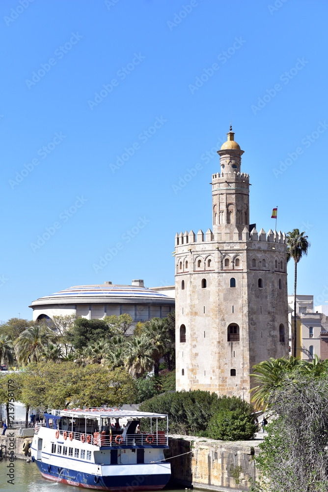 Spain, Seville, Torre del Oro, the Golden tower and cruise boat on the river Guadalquivir