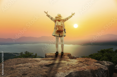 backpacker woman open hand in mountain with sunset or sunrise background