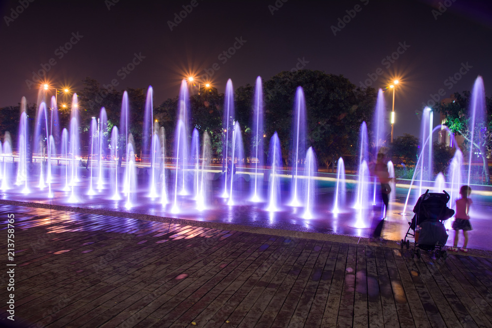 Obraz premium Fountain colored water show. Colorful fontain light in city