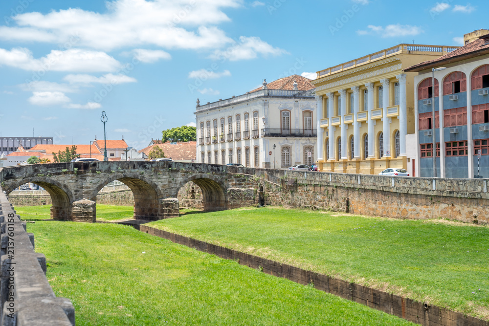 Old brick bridge in São João del Rei, Brazil with historic buildings in the background