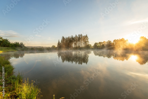 Morning fog on the forest lake.