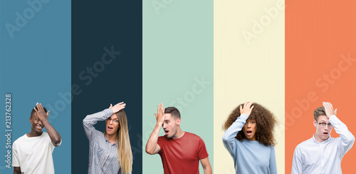 Fotografía Group of people over vintage colors background surprised with hand on head for mistake, remember error