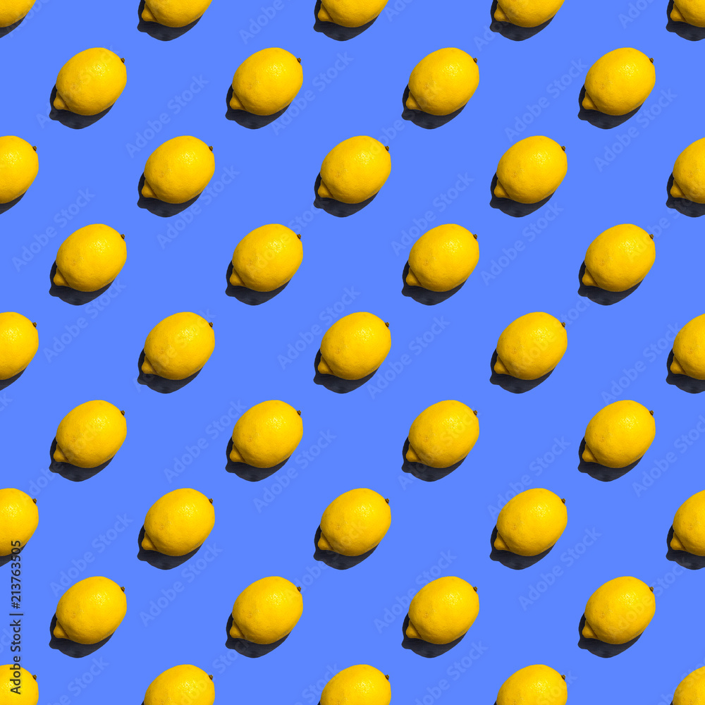 Seamless pattern of lemons on violet background; flat lay