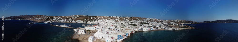 Aerial ultra wide panoramic drone view of iconic chora of Mykonos island featuring picturesque little Venice, Cyclades, Aegean, Greece