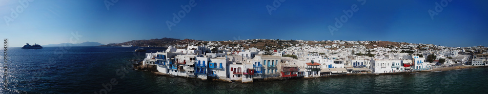 Aerial ultra wide panoramic drone view of iconic chora of Mykonos island featuring picturesque little Venice, Cyclades, Aegean, Greece