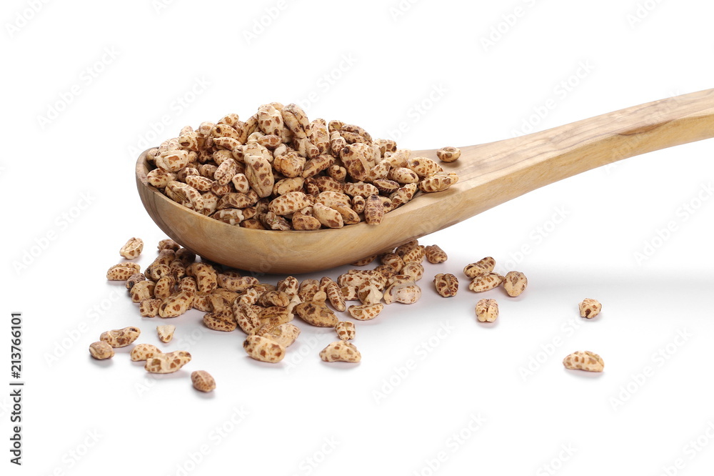 Organic barley flakes in wooden spoon isolated on white background Organic barley flakes in wooden spoon isolated on white background