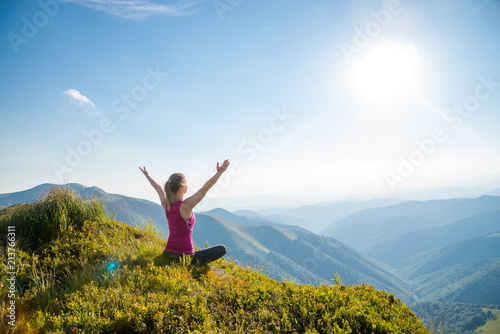 Young woman on the top of mountain