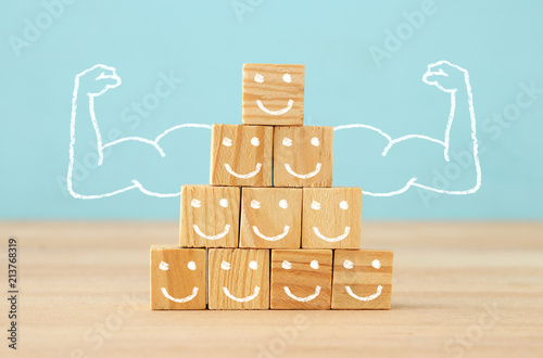 Foto image of wooden blocks with people icons over table ,building a strong team, human resources and management concept