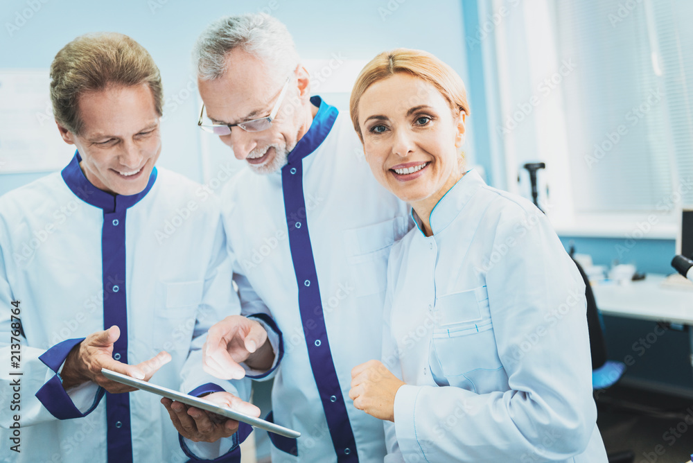 Fototapeta premium Join our team. Amazing woman wearing medical uniform, posing on camera