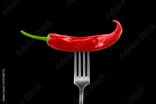 glossy juicy hot chili pepper on a fork © Sergey