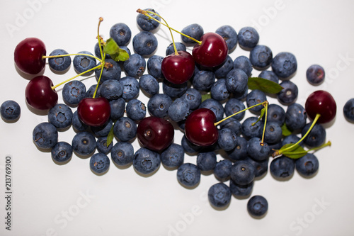 Ripe tasty cherry and blueberry on white background, top view