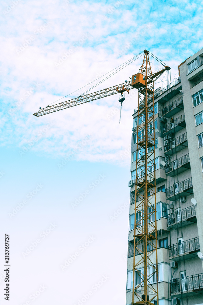 Fototapeta premium Construction crane against the building