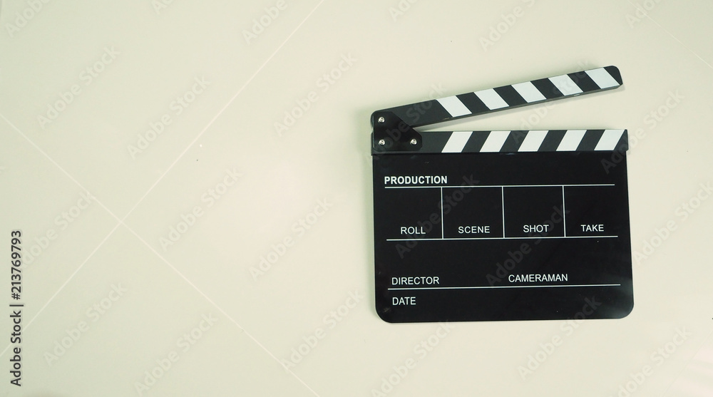 Clapper board or clap board or movie slate use in video production or movie and cinema industry. It's black color on white background. Top view angle.